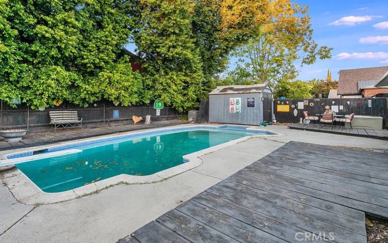 The private backyard will be a favorite entertainment destination with its sparkling in ground pool, wood decks and gated side yards.