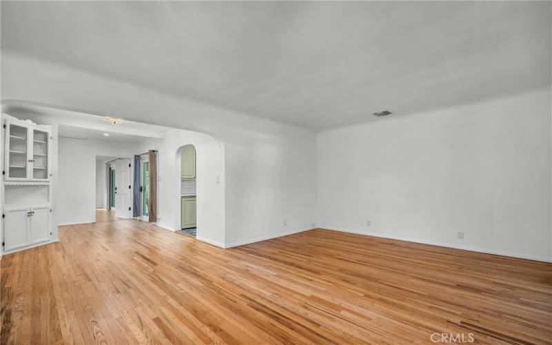 Charming living room with built ins, and archways