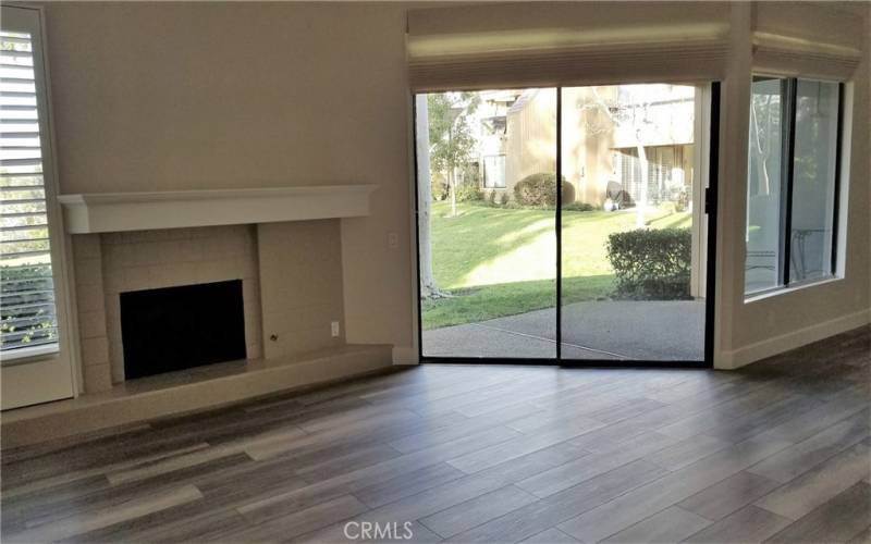 Living Room with fireplace and sliding doors to outdoor patio and beautiful yard