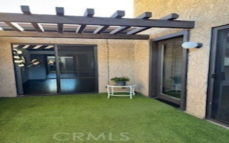 Patio with main entrance to the home and secondary entrance to the bedroom.