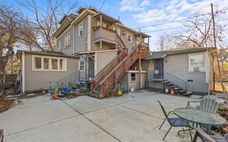 Back of the building, staircase to upstairs units, under stairs is the laundry room