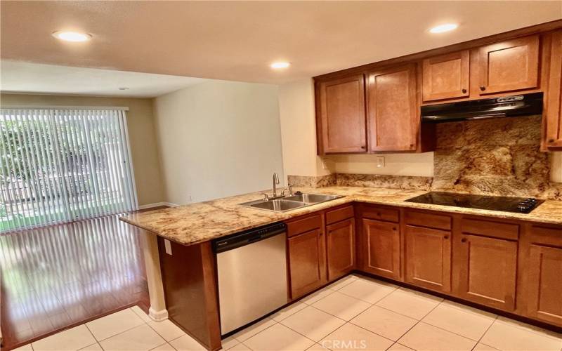 Kitchen open to den with sit-up breakfast bar