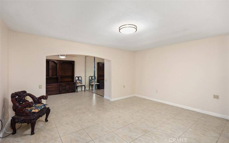 MASTER SUITE WITH AN ARCHWAY LEADING TO THE ENCLOSED PATIO FOR ADDITIONAL ROOM AND STORAGE...