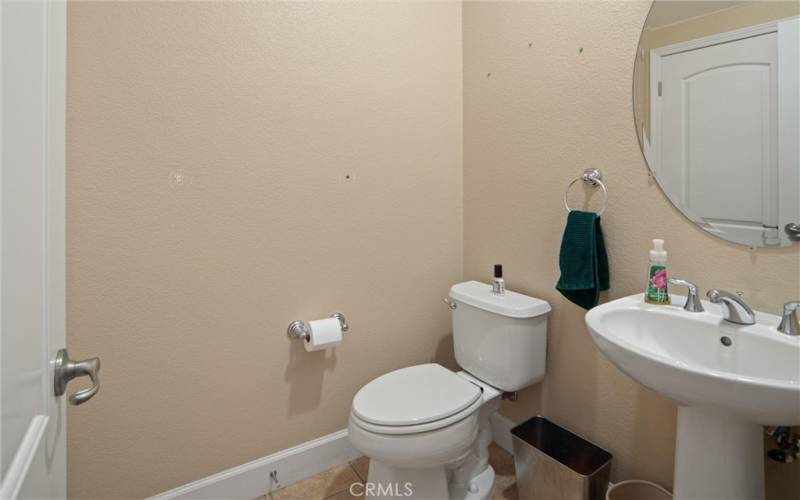 Downstairs half bath with storage behind door