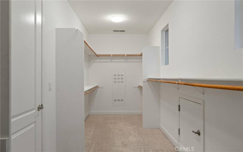 Primary bedroom walk in closet