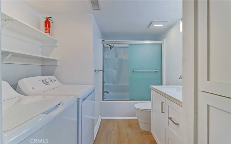 Secondary Bathroom Quartz Top Vanity, and Bathtub Shower Combination.