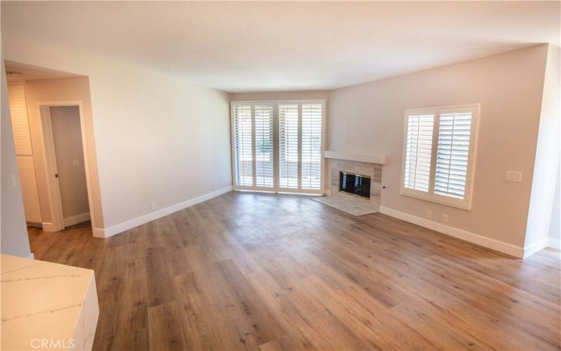 LIVING ROOM WITH SLIDING GLASS DOOR LEADING TO ENCLOSED PATIO