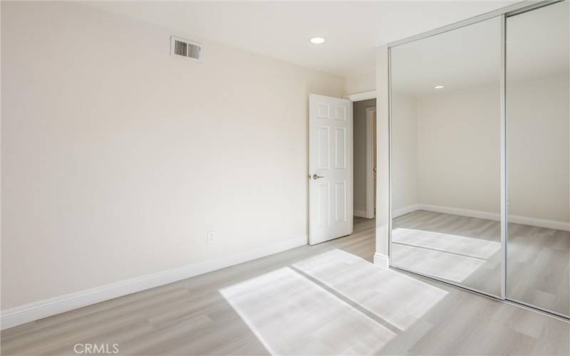 2nd bedroom with mirror closet door & recessed lights