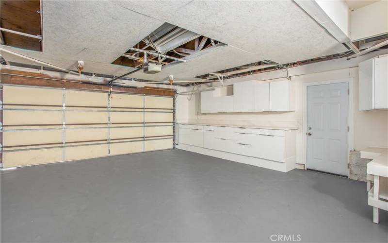 Garage has plenty of cabinets & large Quartz counter top