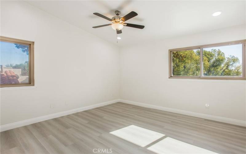 Master bedroom with celing fan, recessed lights, & mirror closet doors