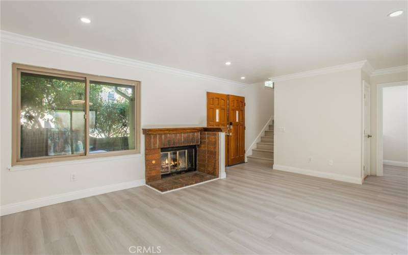 Large living room with fireplace & window to courtyard