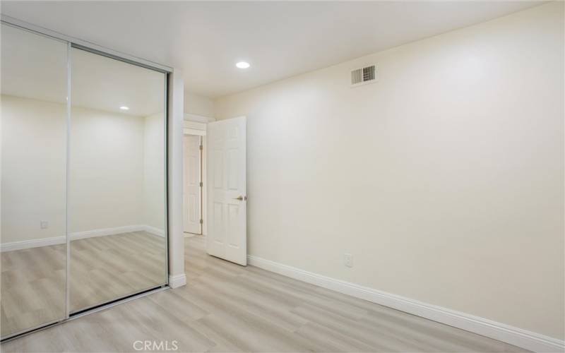 1st bedroom with mirror closet door & recessed lights