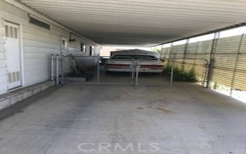 Extended car port, shed beyond