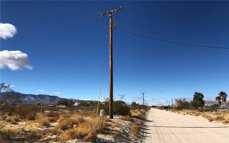 Electrical Pole is at the adjoining parcel. I measured an approximate distance to the NW corner of your parcel about 295 feet.