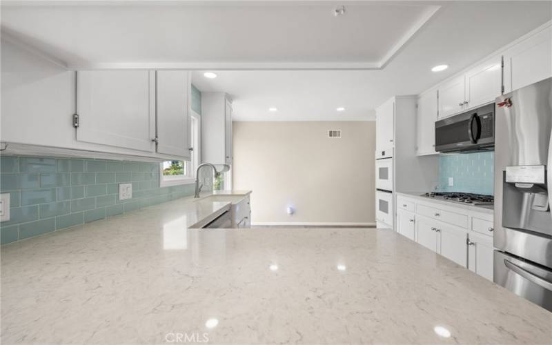 Kitchen with white cabinets and ocean views