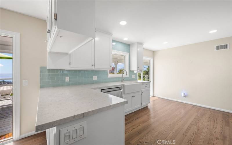 Kitchen with white cabinets and ocean views