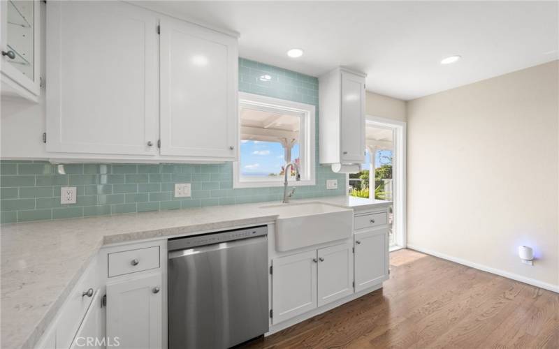 Kitchen with white cabinets and ocean views