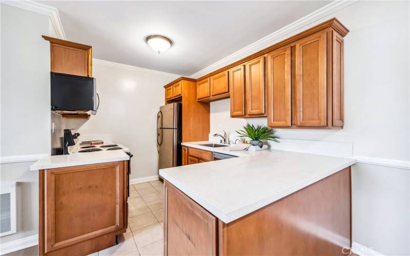 New quartz counters, stainless sink and faucet.  All appliances included