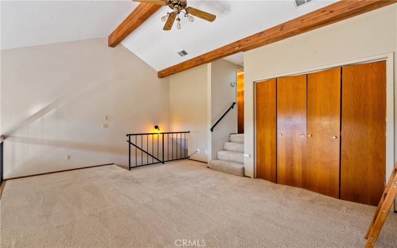 Taking steps up to the loft you are impressed by the openness and grandeur of this condominium. The clerestory windows allow you to easily take in natural light with the privacy they allow.