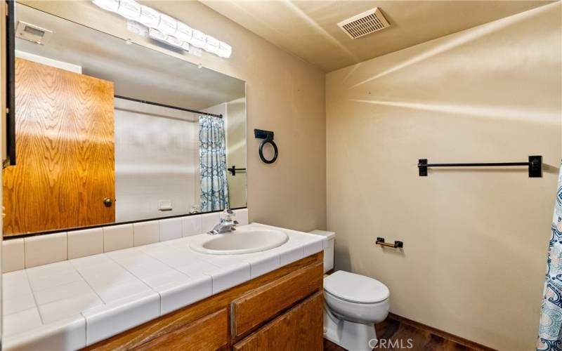 The second-floor full bath is situated between two bedrooms.