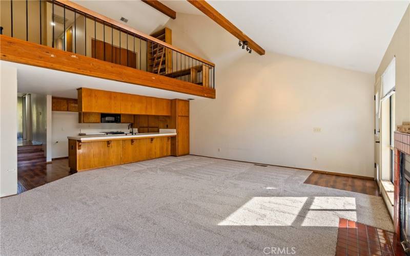 With a high vaulted ceiling, the living room opens upward to lovely clerestory windows.