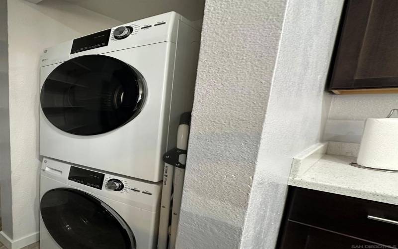 Stacked laundry located in the kitchen area