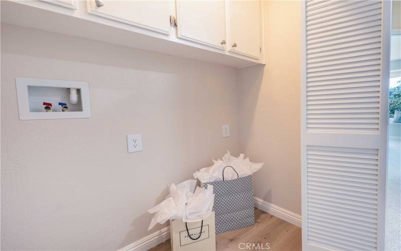 Indoor Laundry facilities with extra cabinetry storage