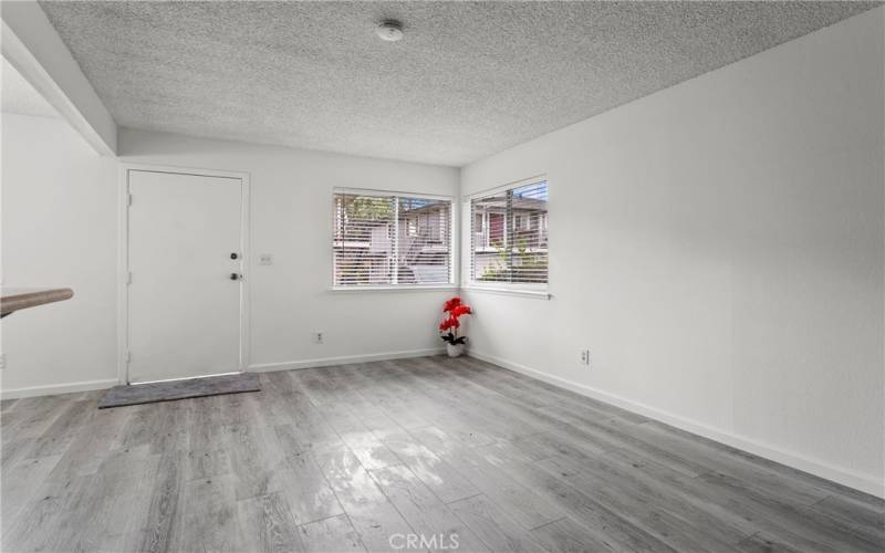 Complete front view of living room. New luxury laminate plank flooring.