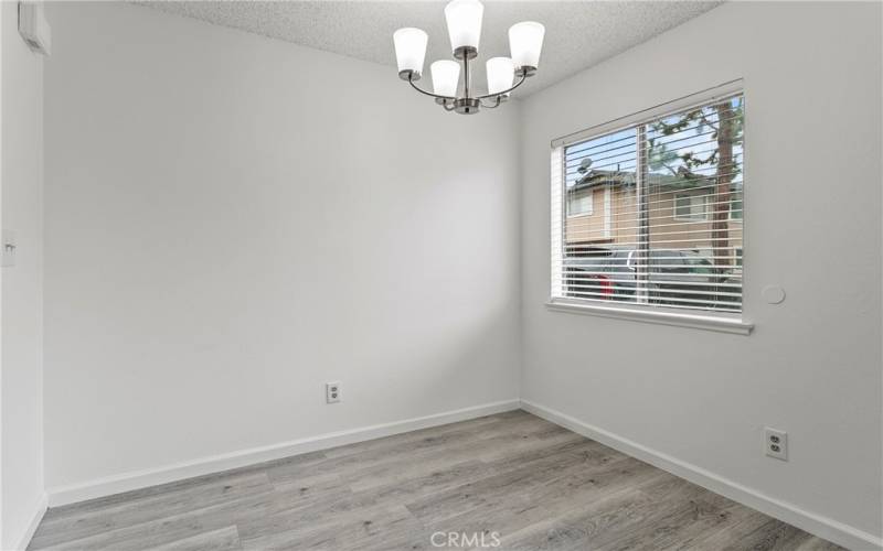 Dining area, new light fixture, window with new blinds.