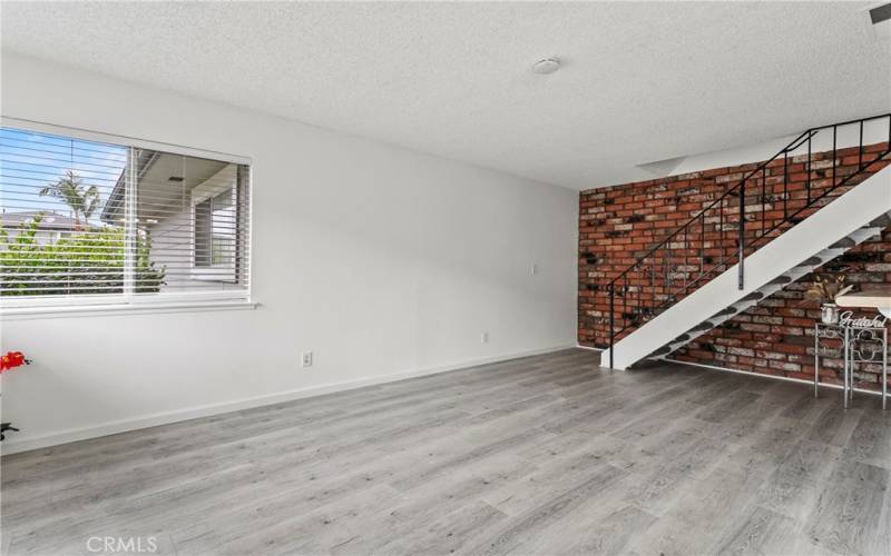 Light & bright living room. New luxury laminate plank flooring on first level.