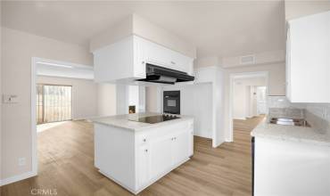 Updated open layout kitchen with additional storage and seating in the island. Quartz countertops and new appliances