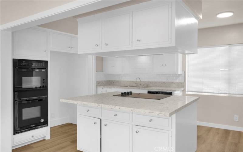 This kitchen island has additional storage underneath, which is a great way to maximize space. There is also additional seating available, which is a nice bonus.