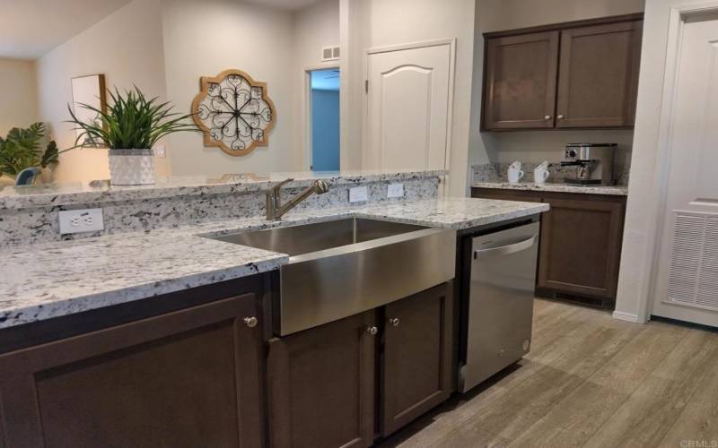 Granite and farmhouse sink in kitchen