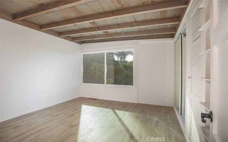 Back bedroom with large window overlooking yard