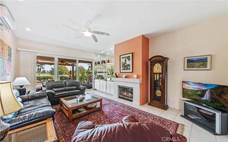 Living room with gas fireplace and new dual paned slider open to patio