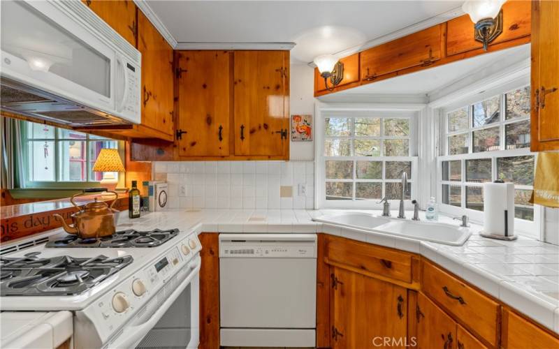 Well equipped kitchen with dishwasher, oven, stove and microwave.