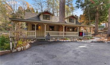 Front view of home with covered deck and level 4 car or RV praking.