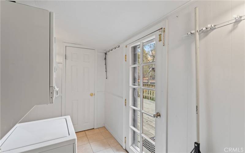 hallway from kitchen to half bathroom. Exterior door to back deck for barbecuing.