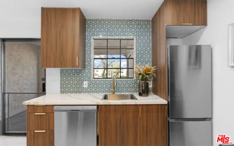 Fully remodeled kitchen with designer tile accents.