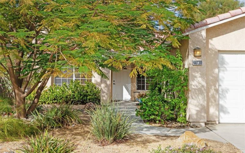 Mature trees and attractive desert tolerant landscaping accentuate this charming single story home.