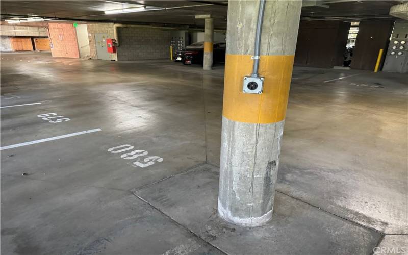 Parking space with electric car charging available and storage shed