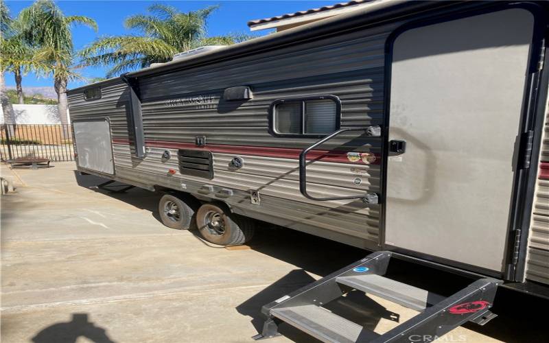 Side yard fenced RV parking pad.