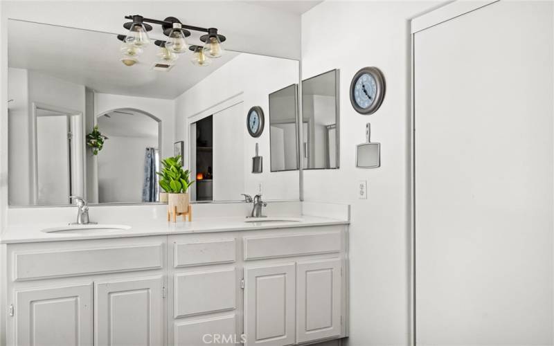 Primary suite bath with double sinks.