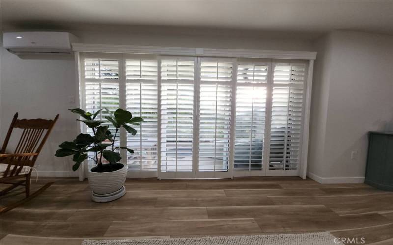 View of the Patio off the Living Room. Mini Split AC and Heat above left.