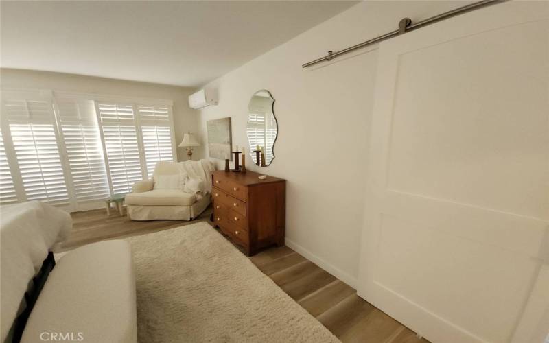  View of Bedroom Patio behind Plantation Shutters. Mini Split AC/Heat visible upper right corner.