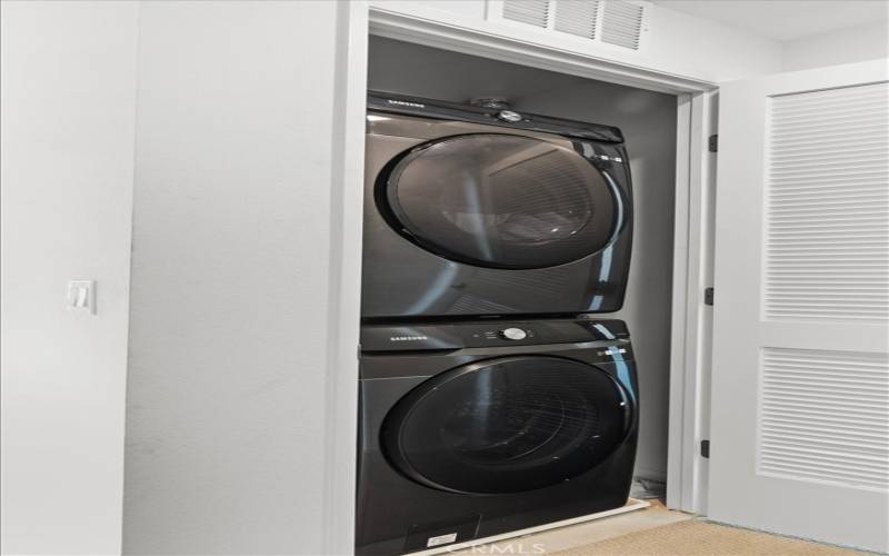 Stackable washer and dryer located conveniently on the top floor between the two bedrooms.