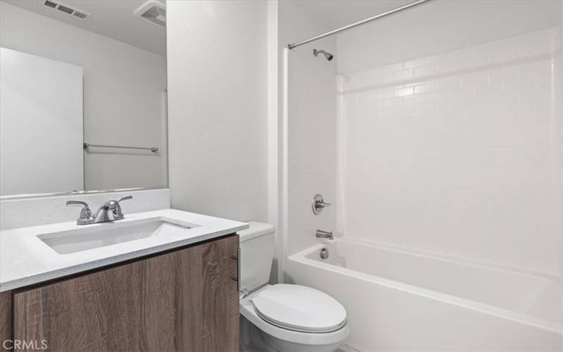 A spacious second full bathroom located next to Bedroom #2 for easy access.