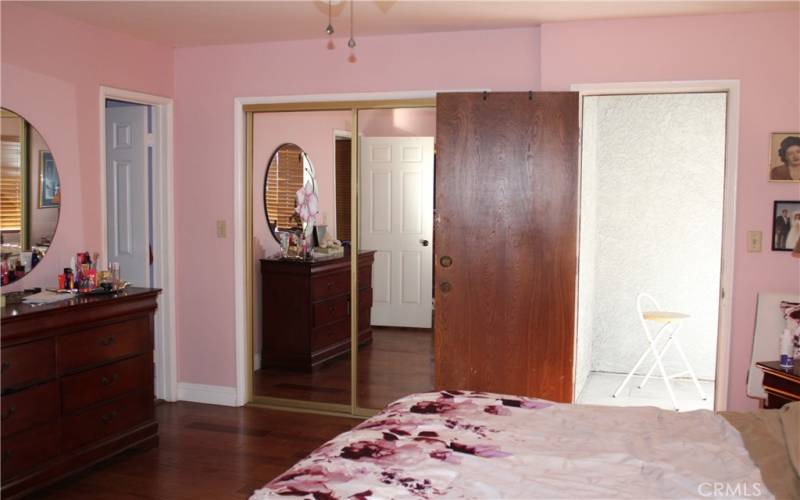 Primary bedroom with walk-in closet and Patio