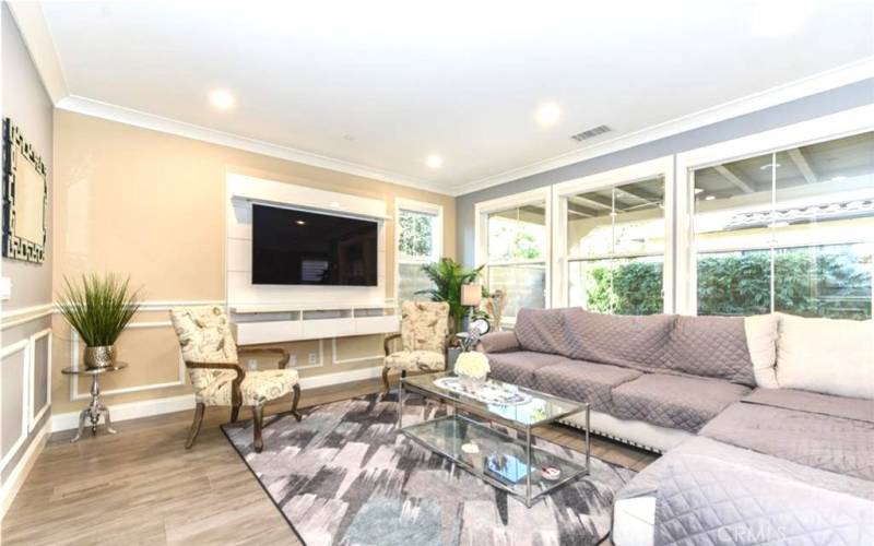 Family Room (staged) with built-in wall mounted media cabinet