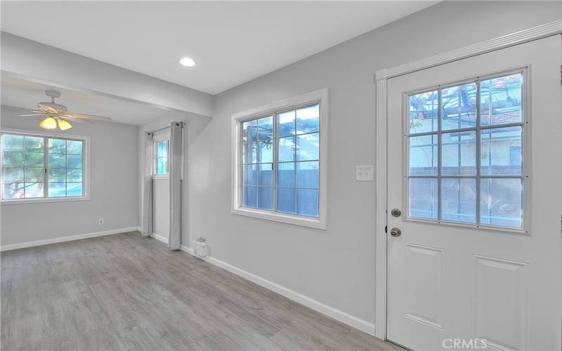 Door to backyard with a screened door for fresh air.